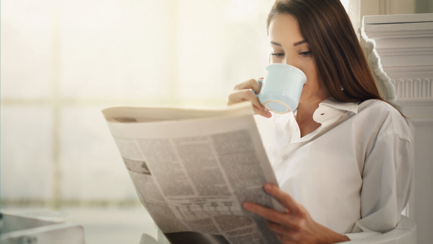 Person reading about estate planning after divorce in a newspaper