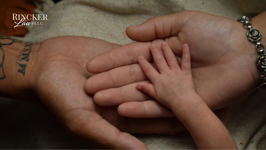 Adult and child hands touching, symbolizing legacy, values, and generational estate planning.